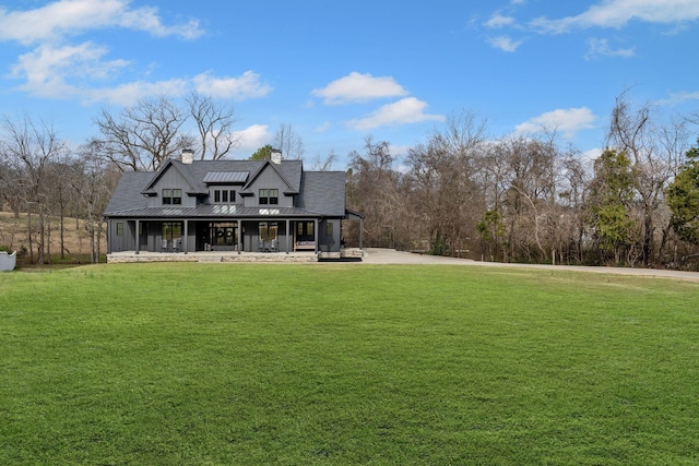 exterior space with covered porch and a front lawn