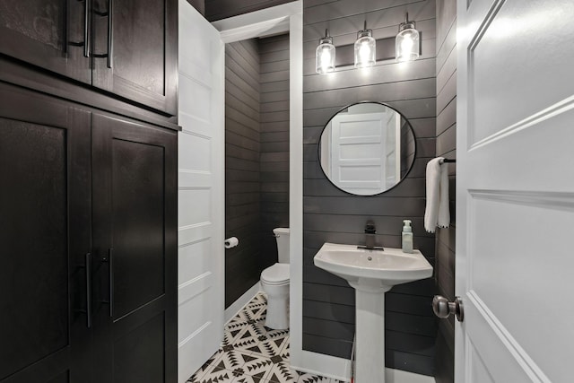 bathroom featuring sink, toilet, and tile patterned flooring