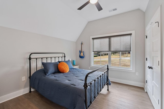 bedroom featuring hardwood / wood-style flooring, lofted ceiling, and ceiling fan