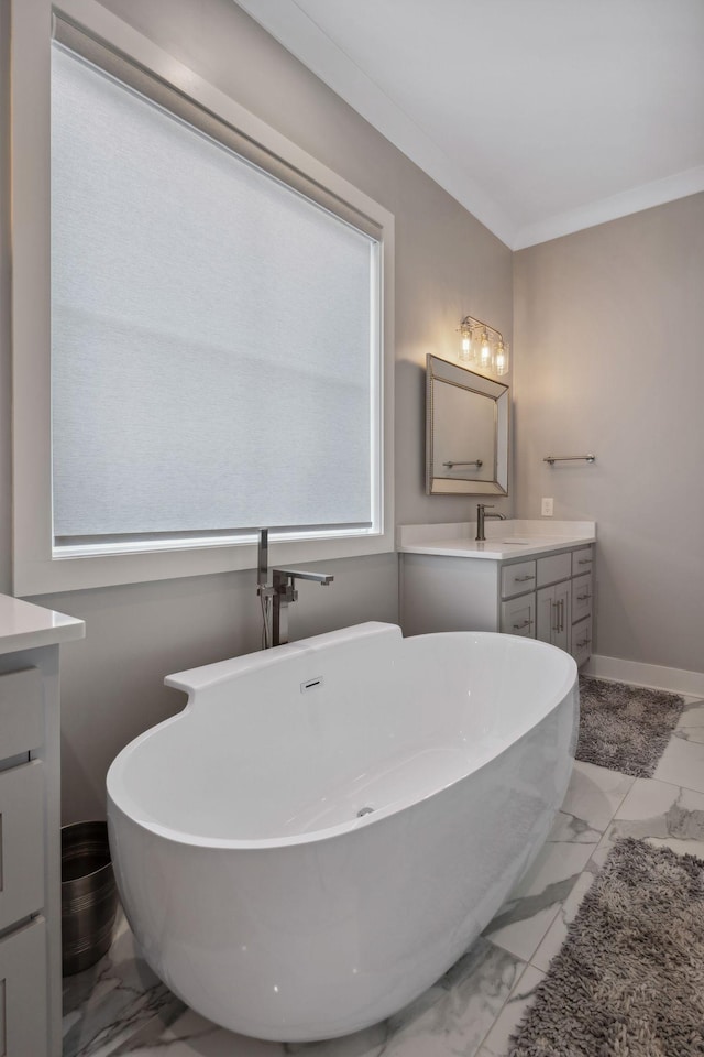 bathroom with crown molding, a tub to relax in, and vanity