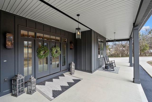 view of exterior entry with french doors and covered porch