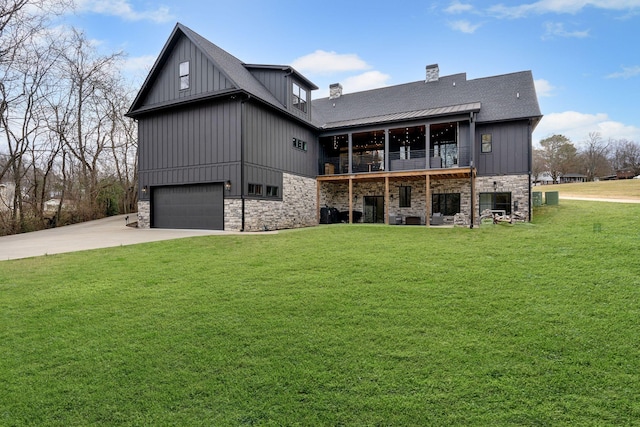 back of house with a garage and a lawn