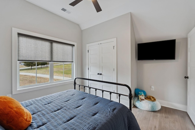 bedroom featuring wood-type flooring, vaulted ceiling, and ceiling fan