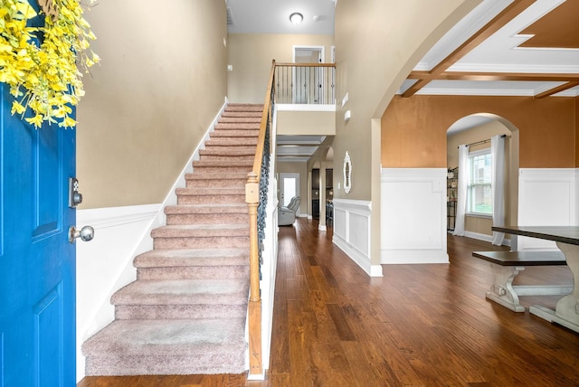 foyer entrance with beamed ceiling and dark hardwood / wood-style flooring