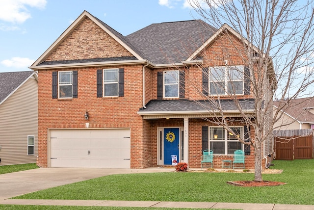 view of front of house featuring a garage and a front lawn