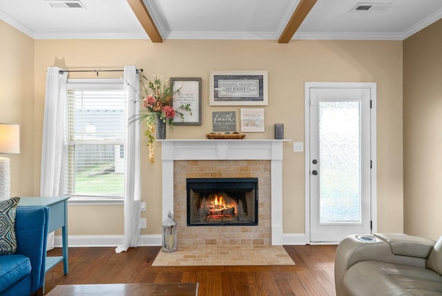 living room featuring beam ceiling, crown molding, a fireplace, and dark hardwood / wood-style flooring