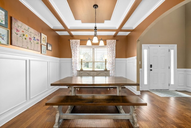 dining space with coffered ceiling, dark hardwood / wood-style flooring, and beam ceiling