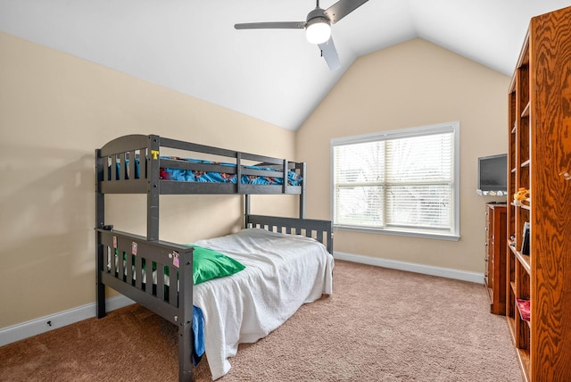 carpeted bedroom featuring ceiling fan and vaulted ceiling