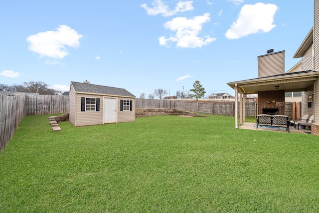 view of yard with a storage shed, a fireplace, and a patio