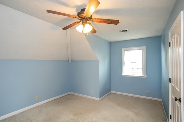 bonus room with vaulted ceiling, light colored carpet, and ceiling fan