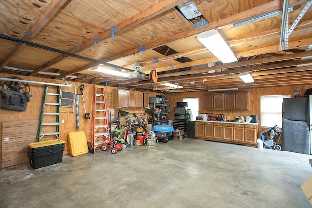 garage with wooden walls and a workshop area