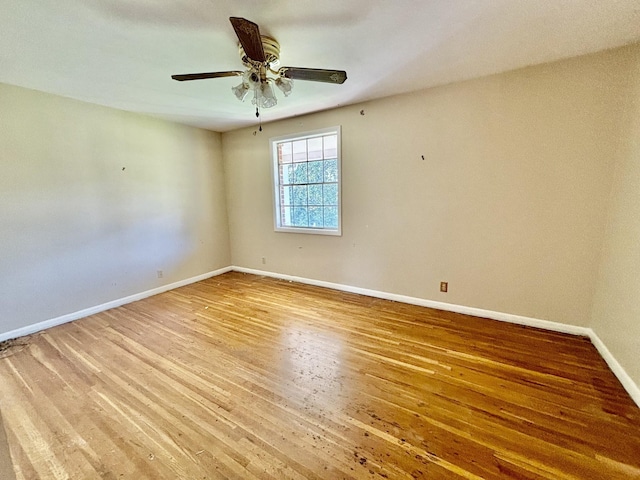 empty room featuring hardwood / wood-style flooring and ceiling fan