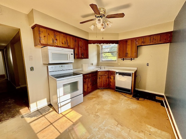 kitchen featuring ceiling fan, sink, and white appliances