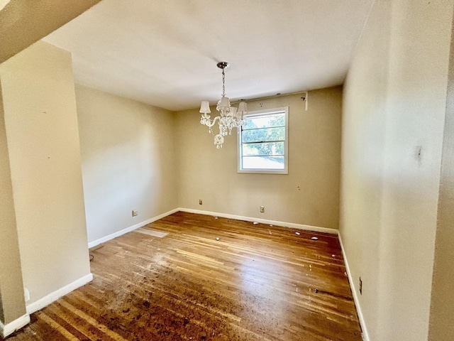 unfurnished dining area with dark hardwood / wood-style flooring and a notable chandelier