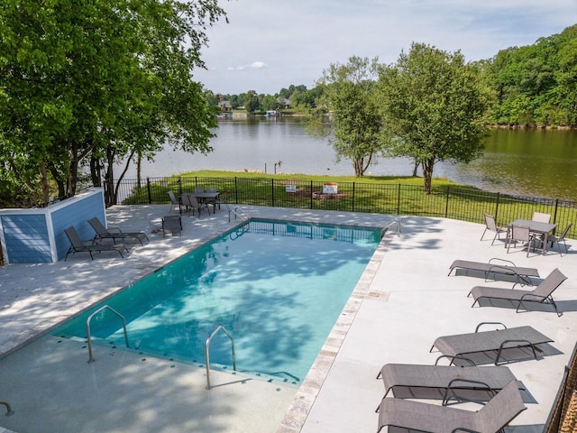 view of pool featuring a patio area and a water view