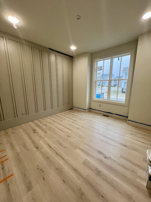 spare room with light hardwood / wood-style floors