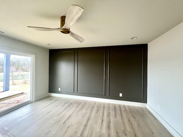 unfurnished room with ceiling fan and light wood-type flooring