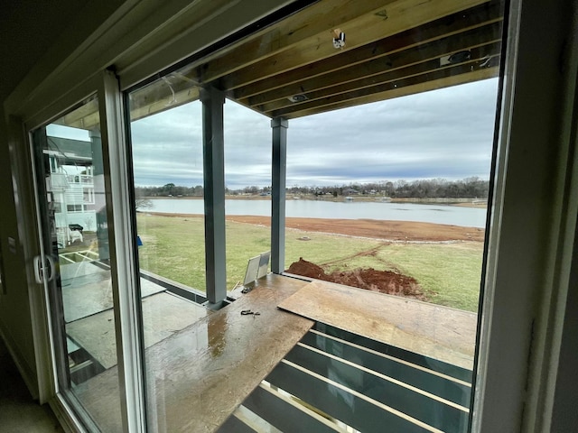 doorway featuring a healthy amount of sunlight and a water view