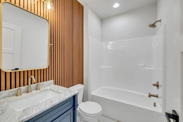 bathroom with toilet, shower / bath combination, recessed lighting, and vanity