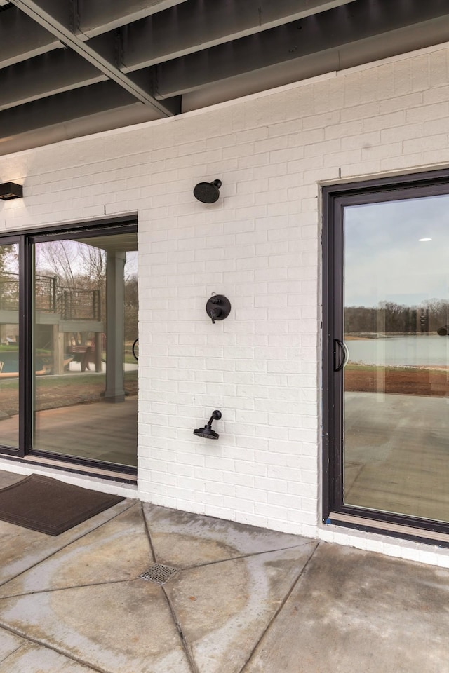 property entrance featuring brick siding