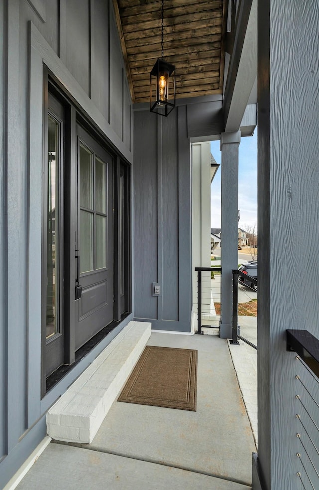 entrance to property with a balcony and board and batten siding