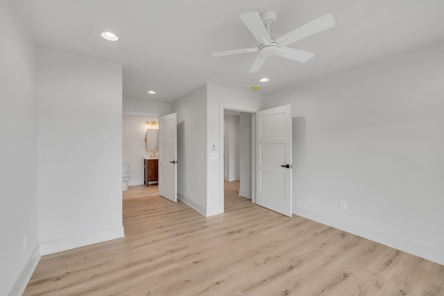 unfurnished bedroom featuring ensuite bathroom, ceiling fan, recessed lighting, baseboards, and light wood finished floors