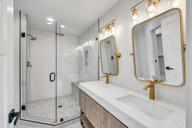 bathroom with double vanity, recessed lighting, a sink, and a shower stall