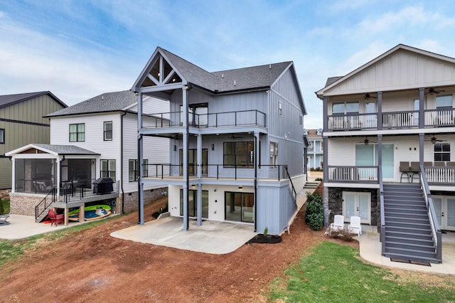 back of house with a patio, a ceiling fan, a sunroom, a balcony, and stairs