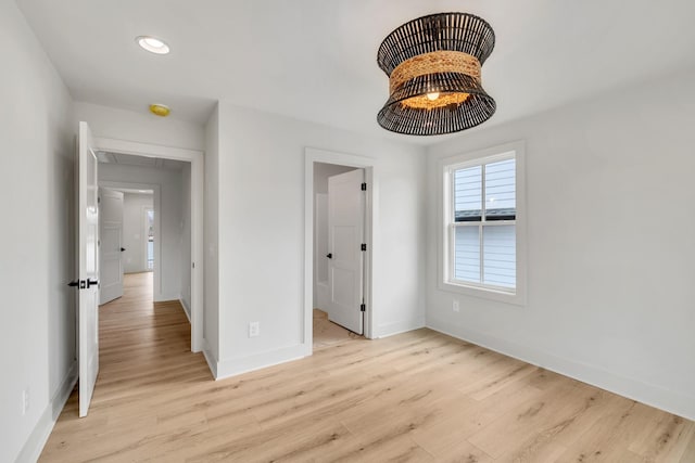 unfurnished bedroom featuring attic access, recessed lighting, baseboards, and light wood finished floors