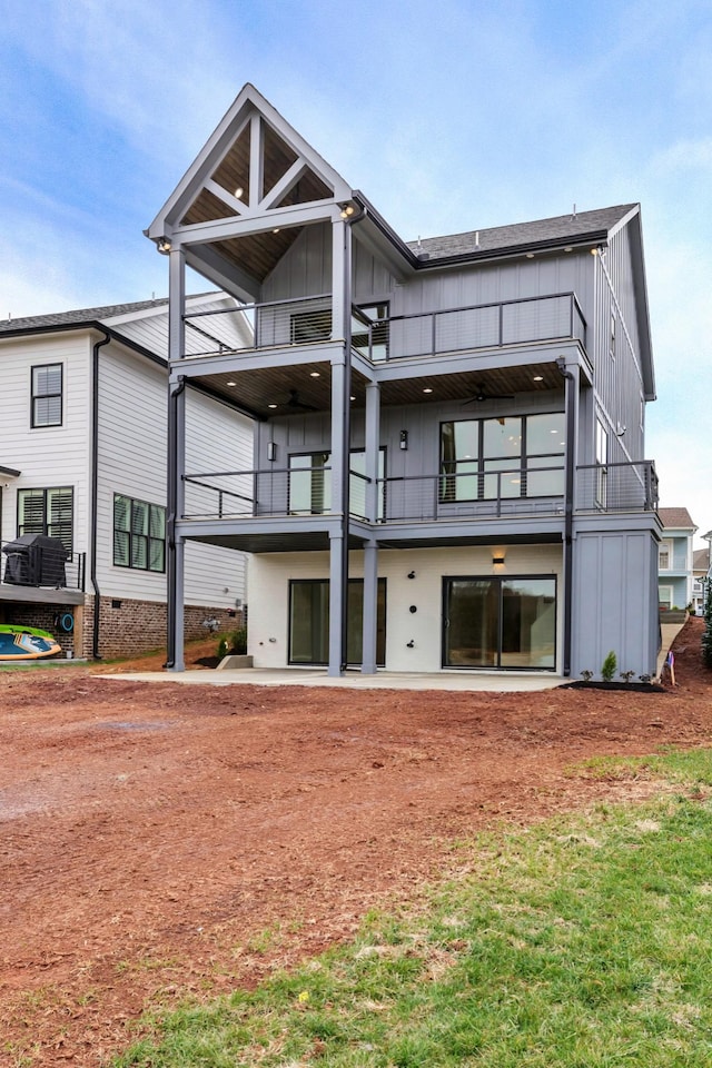 rear view of property featuring board and batten siding and a balcony