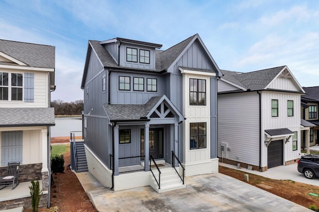 modern farmhouse with an attached garage, covered porch, a shingled roof, concrete driveway, and board and batten siding