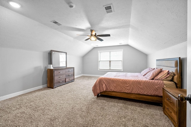 carpeted bedroom featuring a textured ceiling, vaulted ceiling, and ceiling fan