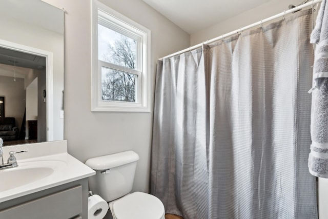 bathroom featuring vanity, toilet, and a shower with shower curtain