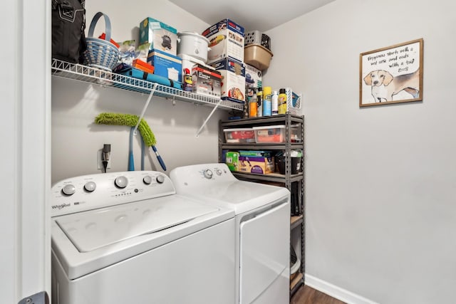 laundry area with dark hardwood / wood-style flooring and washer and dryer