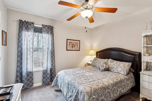 bedroom featuring ceiling fan, multiple windows, and dark colored carpet