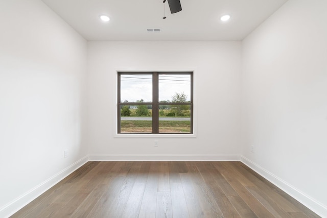 empty room featuring dark hardwood / wood-style flooring and ceiling fan