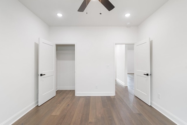 unfurnished bedroom featuring dark wood-type flooring and ceiling fan