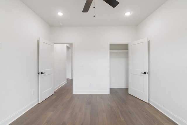 unfurnished bedroom with dark wood-type flooring, ceiling fan, and a closet