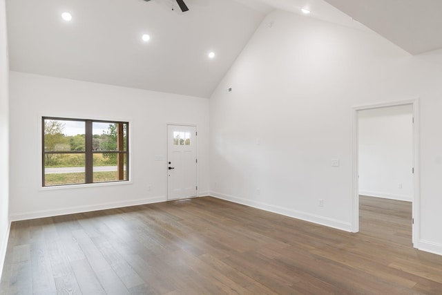 unfurnished room with ceiling fan, dark hardwood / wood-style floors, and high vaulted ceiling