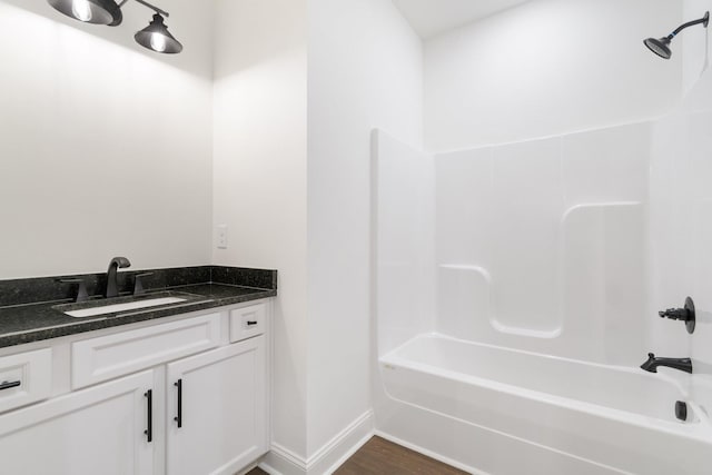 bathroom featuring shower / tub combination, vanity, and hardwood / wood-style floors