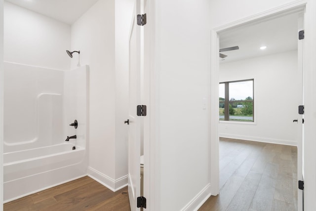 bathroom featuring hardwood / wood-style flooring and bathtub / shower combination