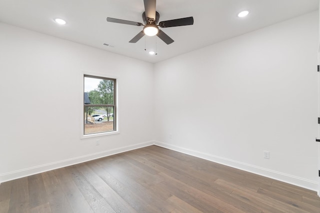 spare room featuring ceiling fan and dark hardwood / wood-style floors