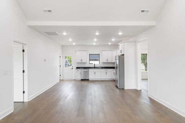 kitchen featuring sink, hardwood / wood-style flooring, white cabinets, and appliances with stainless steel finishes