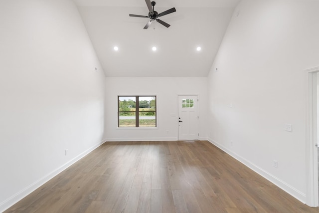 spare room with ceiling fan, wood-type flooring, and high vaulted ceiling