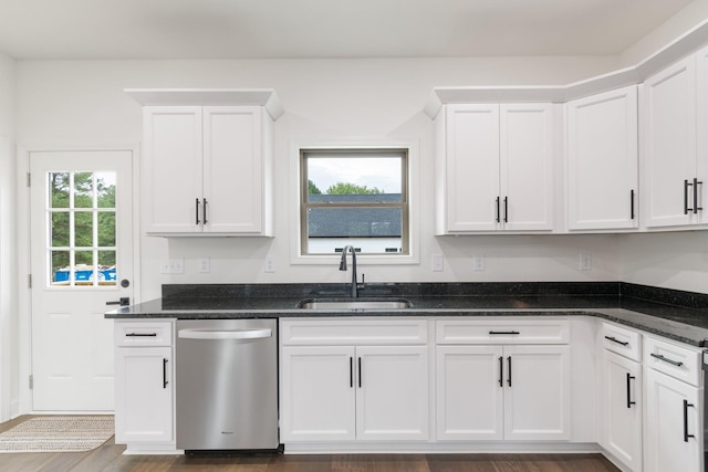 kitchen featuring dark stone counters, dishwasher, sink, and white cabinets