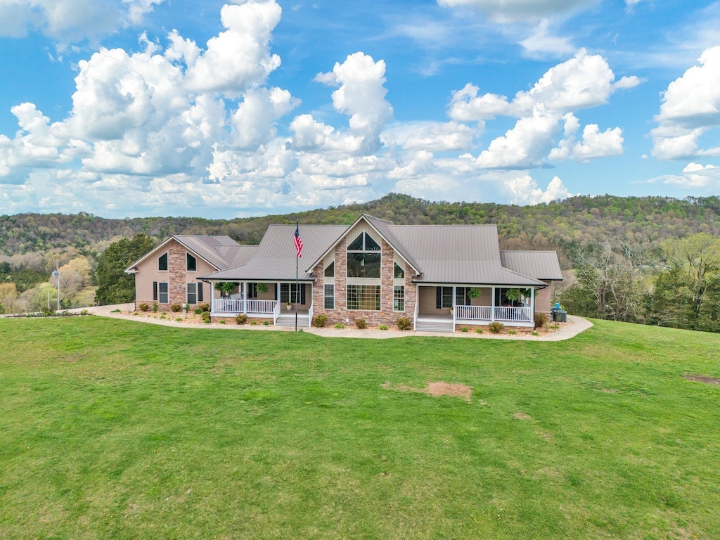 ranch-style house featuring a porch and a front yard