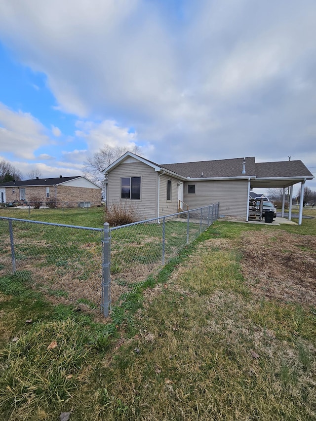 view of front of house with a front lawn and a carport