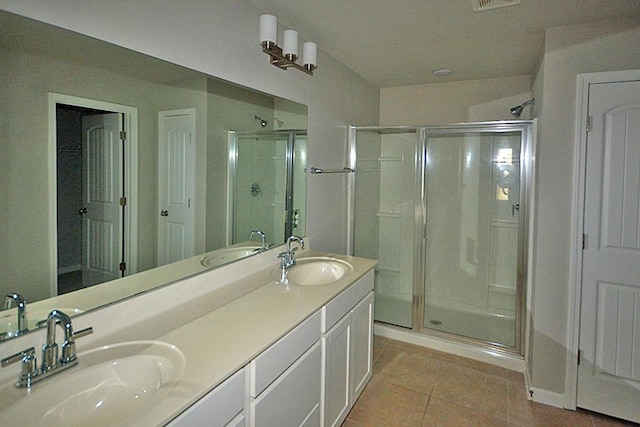 bathroom featuring an enclosed shower, vanity, and tile patterned floors