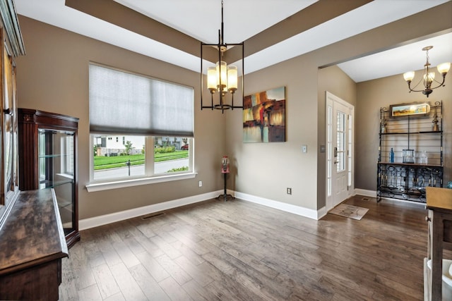 interior space with baseboards, visible vents, a chandelier, and dark wood-style flooring