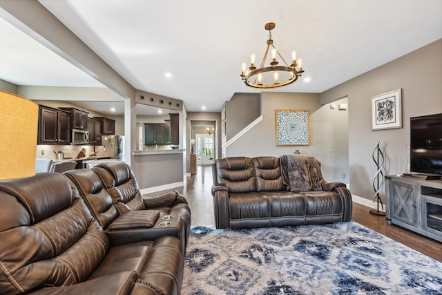 living room with an inviting chandelier and dark hardwood / wood-style floors